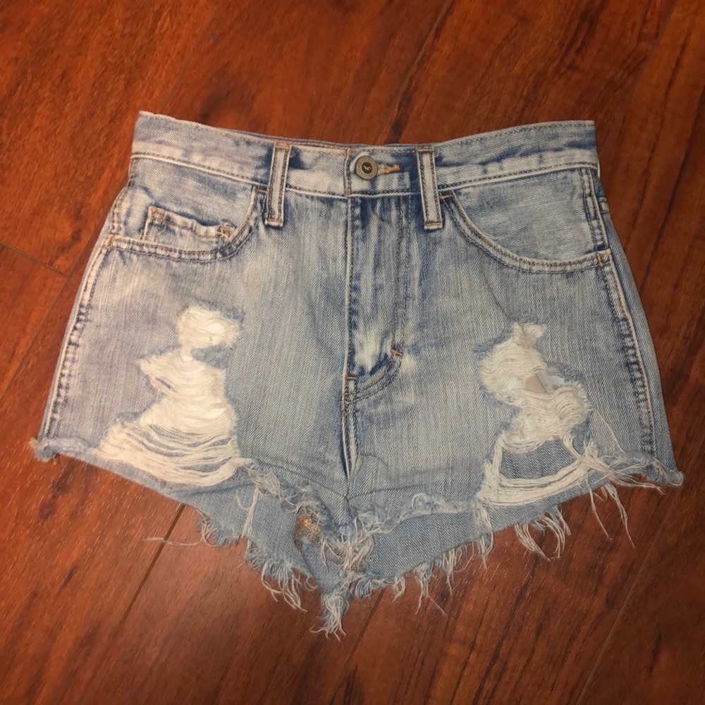 Acid washed, high waisted shorts with lots of rips